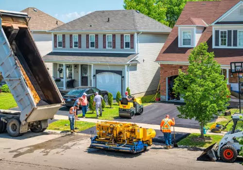 A group of contractors performing Asphalt Paving Services in LaSalle IL for a beautiful home