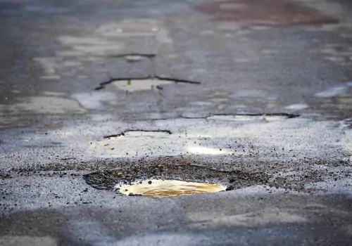 A roadway with potholes needing Asphalt Repair in LaSalle IL