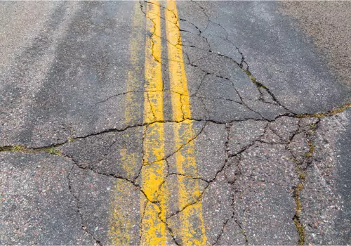 A cracked road needing crack sealing in Illinois