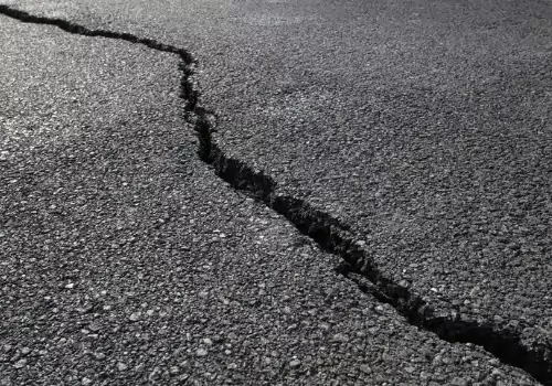 A repaired section of asphalt area is seen. Bercholtd Asphalt is an Asphalt Contractor in Davenport IA.