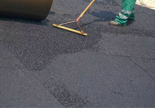 Workers install an asphalt surface. Berchtold Asphalt are Asphalt Contractors in Rock Island IL